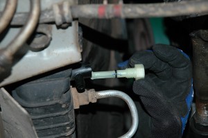 The small drain plug on the lower radiator tank was cracked from heat and age.