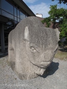 A stone bison stands guard in front of City Hall.