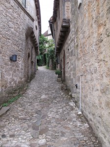 Narrow cobblestone streets twist through the village to small plazas and the towering bell tower of the church.