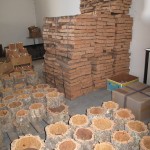 Premium cork, like the stack in the back seen here, is sent to special cork stopper processing factories in northern Portugal.