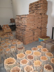 Premium cork, like the stack in the back seen here, is sent to special cork stopper processing factories in northern Portugal.