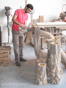 A craftsman at the Cortiçarte-Arte em Cortiça, Lda. Company hones out the center of a first-growth cork tree for use as a decorative planter or perhaps a cute lamp.