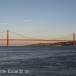 The 25th of April Bridge across the River Tejo was built in 1966 by the American Bridge Company who constructed the San Francisco-Oakland Bay Bridge, not the Golden Gate Bridge but it might explain its similarity in design.