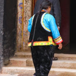 A Tibetan worshipper enters the sanctuary filled with yak butter monuments.